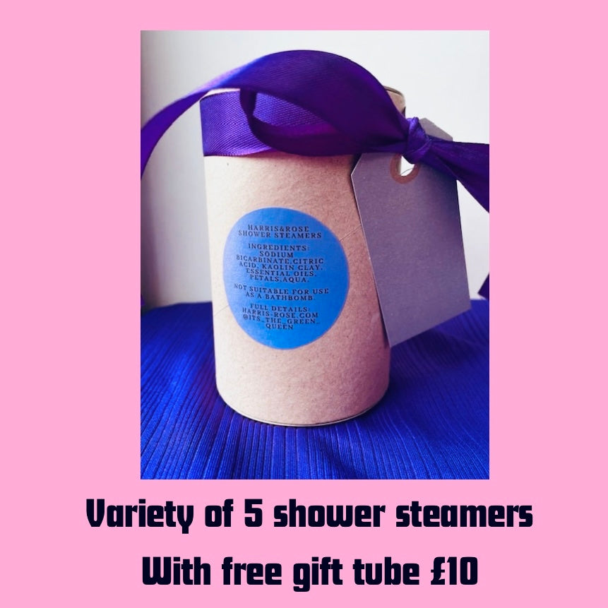 Shower steamers with a purple ribbon and gift tube on a pink background. pack of 5 handmade shower steamers with free gift tube