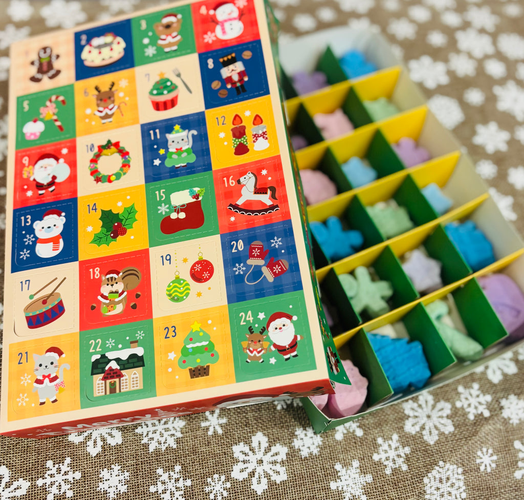 Bathbomb Advent calendar with 24 individual handmade. bathbombs. vegan, cruelty free, colourful designs on a textured surface with snowflake patterns