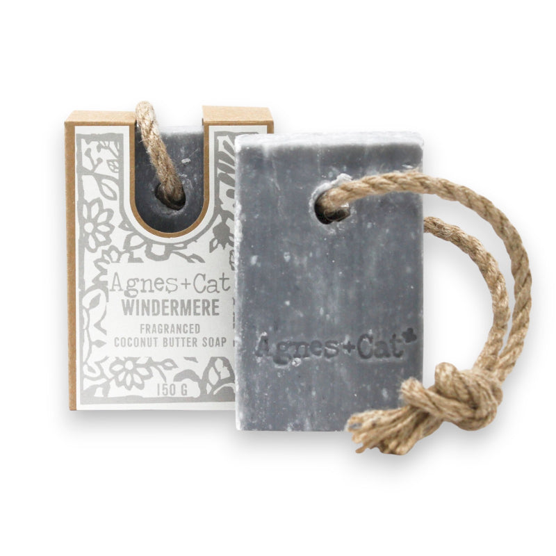 Gray soap bar with rope and packaging labeled 'Agnes + Cat' on a white background. vegan, plastic free, cruelty free.