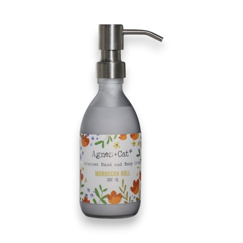 Hand & body lotion dispenser with floral label on a white background. vegan, cruelty free, plastic free.
